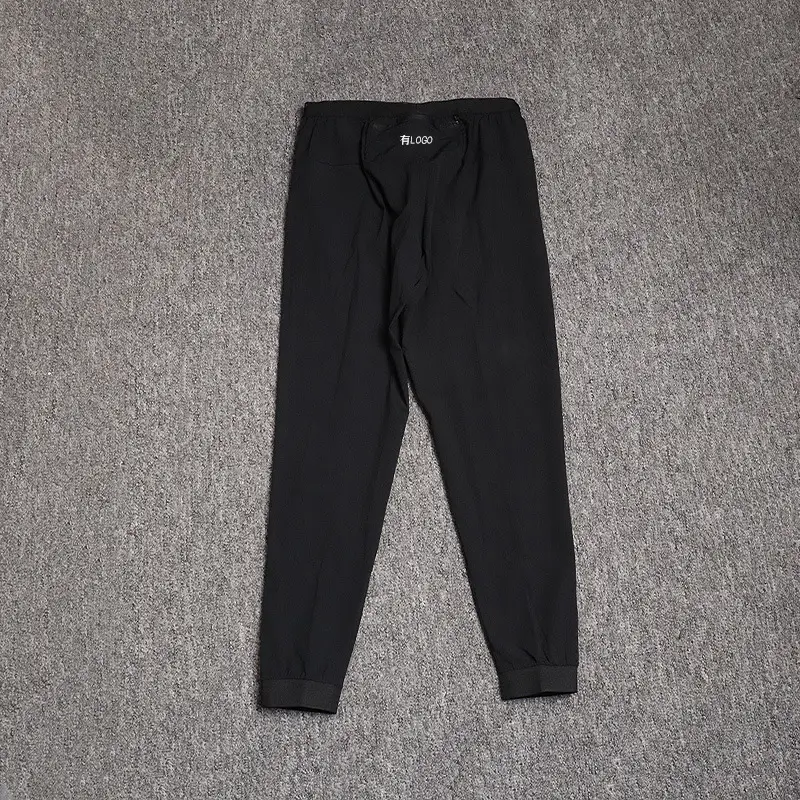 Brand logo in stock woven micro elastic sports pants men's summer loose breathable toe running casual cropped pants