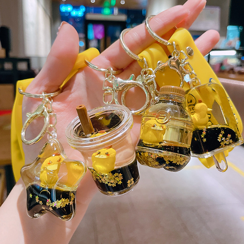 Net red can reach duck key chain oil floating cartoon doll key chain quicksand bottle pendant exquisite gift wholesale