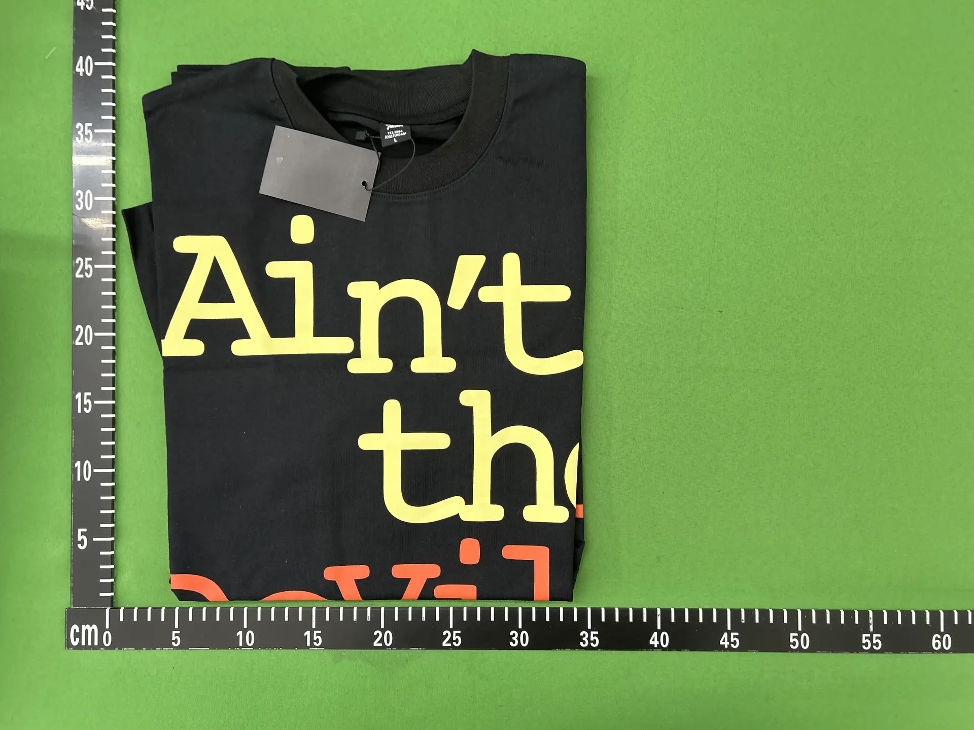 Black T-shirt with yellow and orange text
