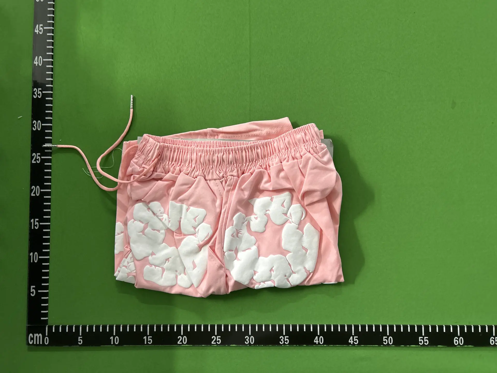 Pink shorts with white floral appliques