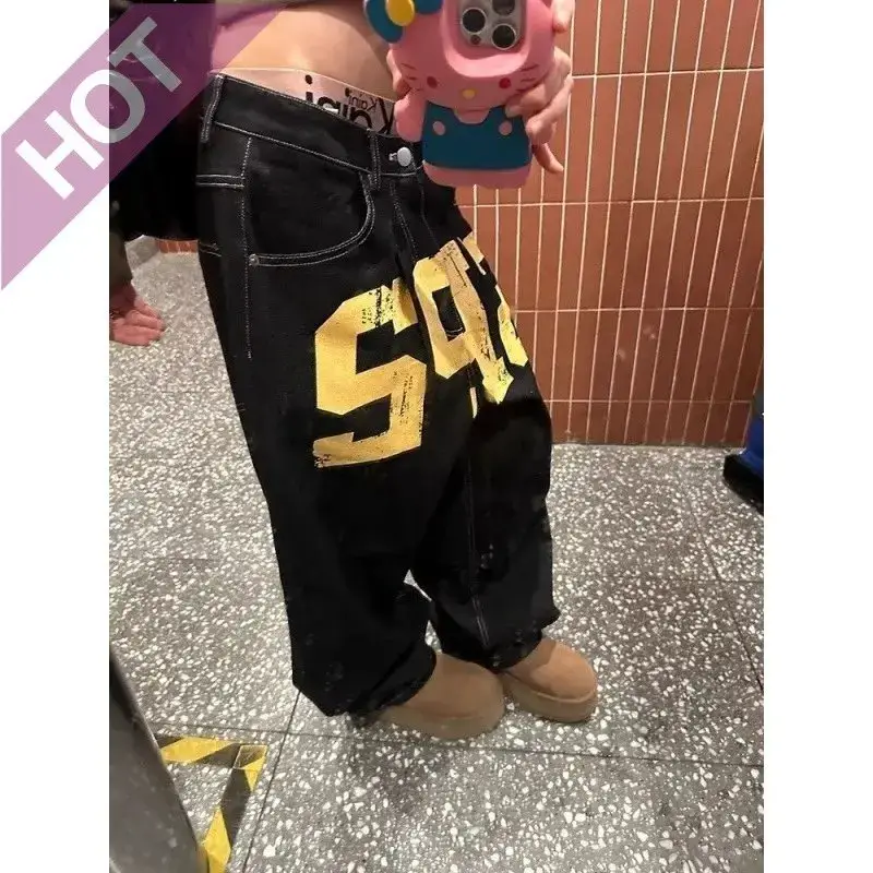 Black wide leg jeans with yellow graphic
