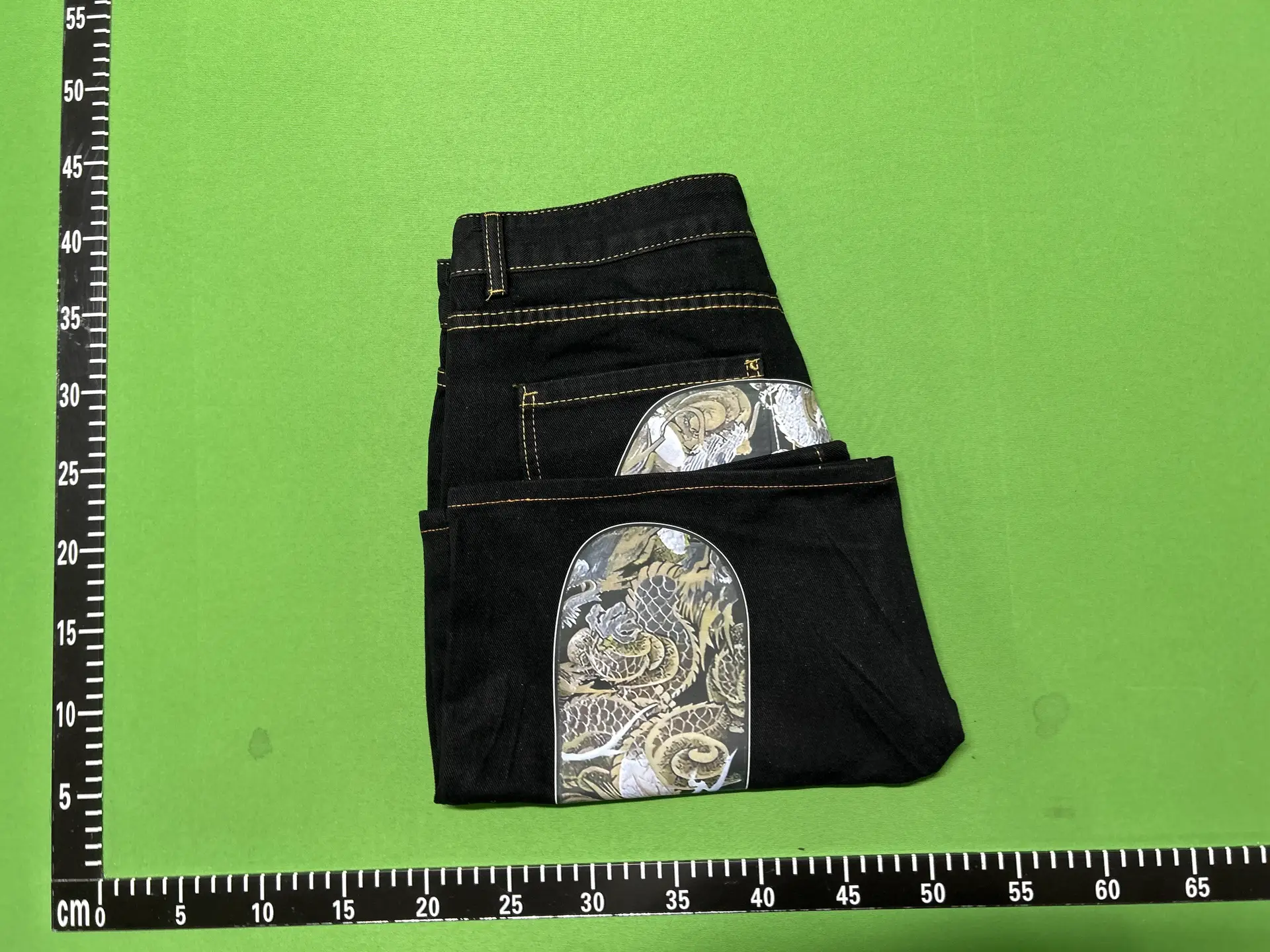 Black denim shorts with dragon print