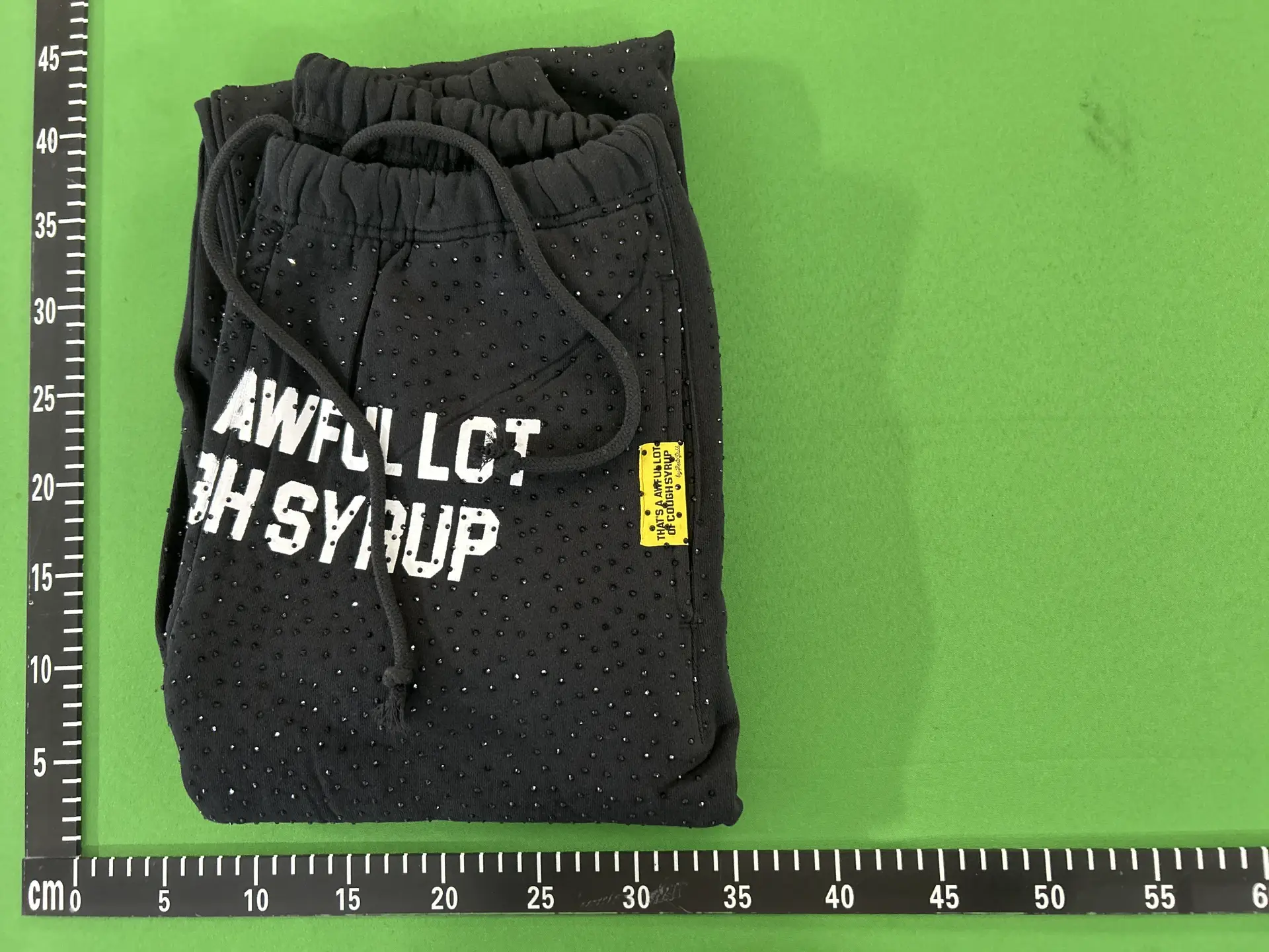 Loose-Fitting Jogger Pants with a Full-Length Rhinestone-Embellished White Letter Logo Printed on Them