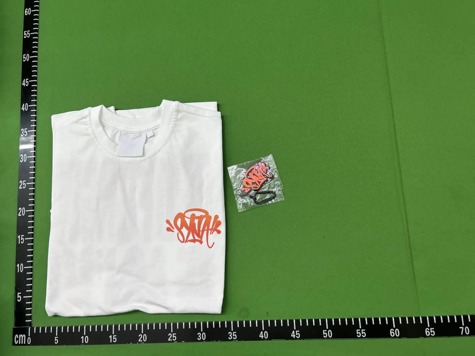 White T-shirt with orange graphic