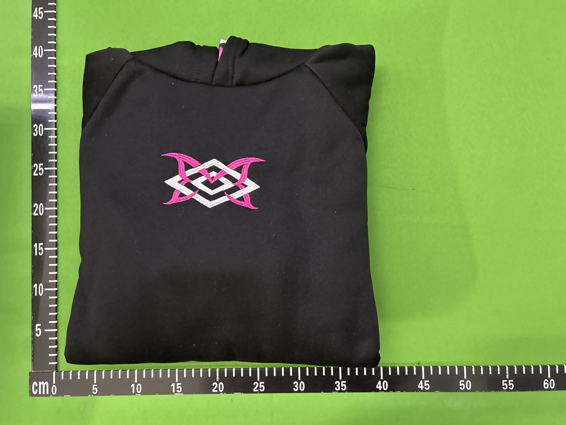 Black hoodie with pink and white logo
