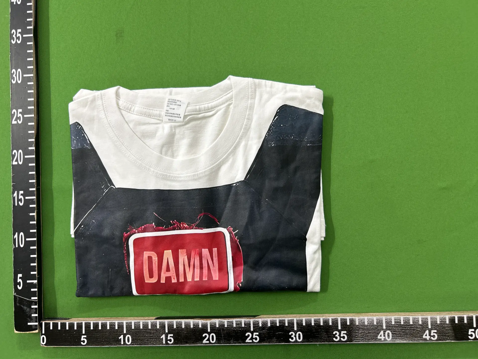 White T-Shirt with DAMN Graphic