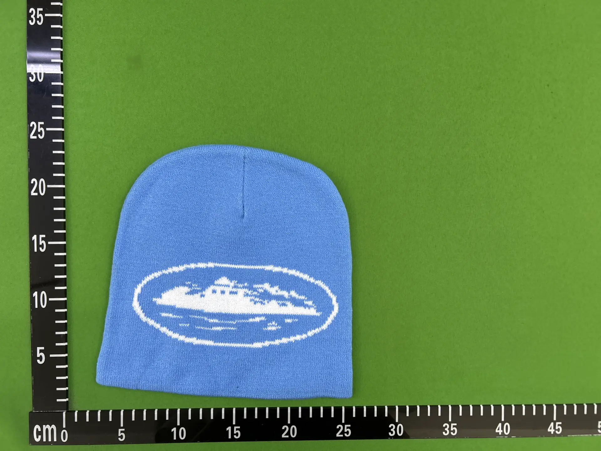 Blue knit beanie with white oval graphic