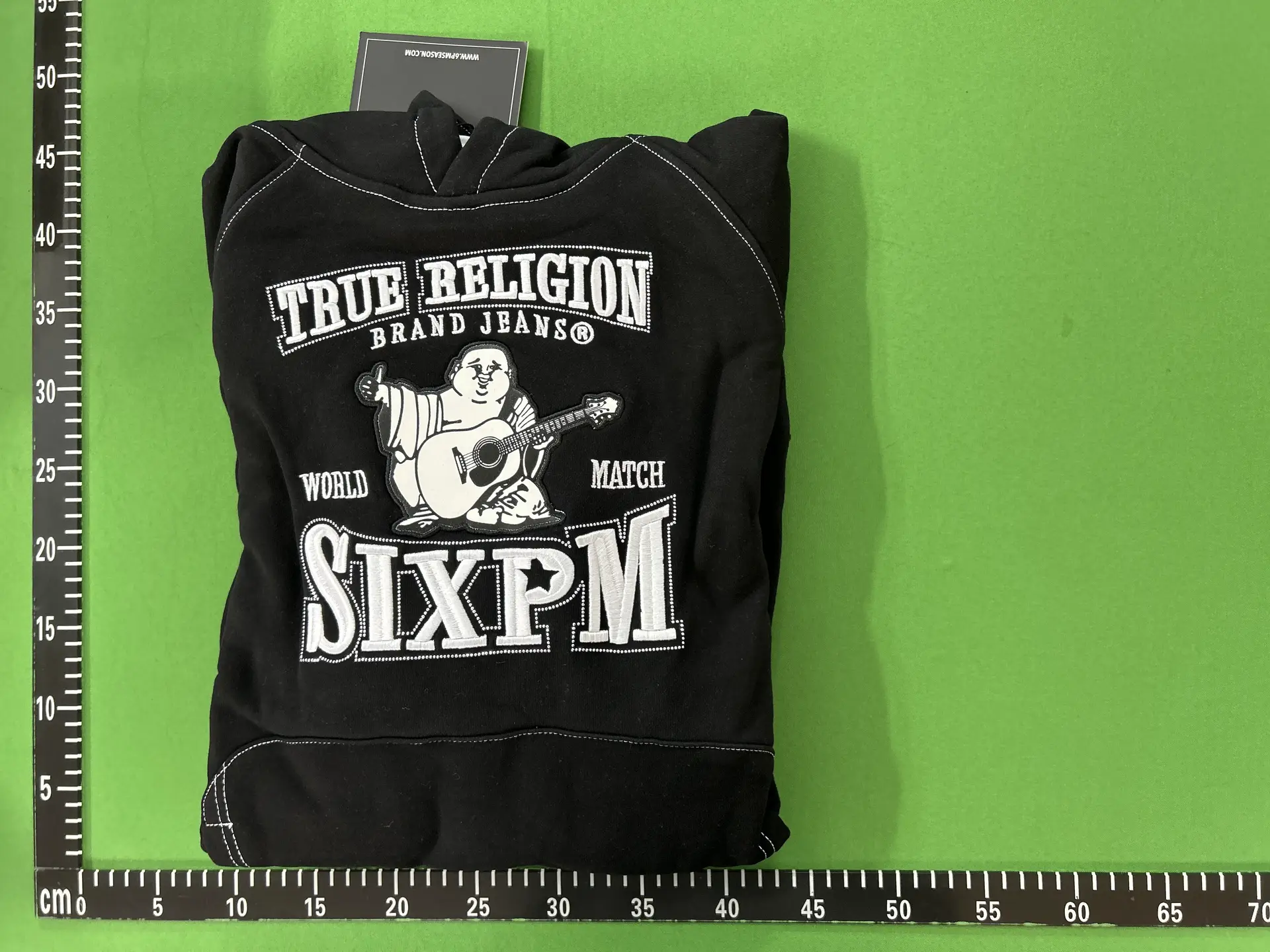 In the Picture, a Bald Man Is Playing Guitar with a Black Hoodie 33122622