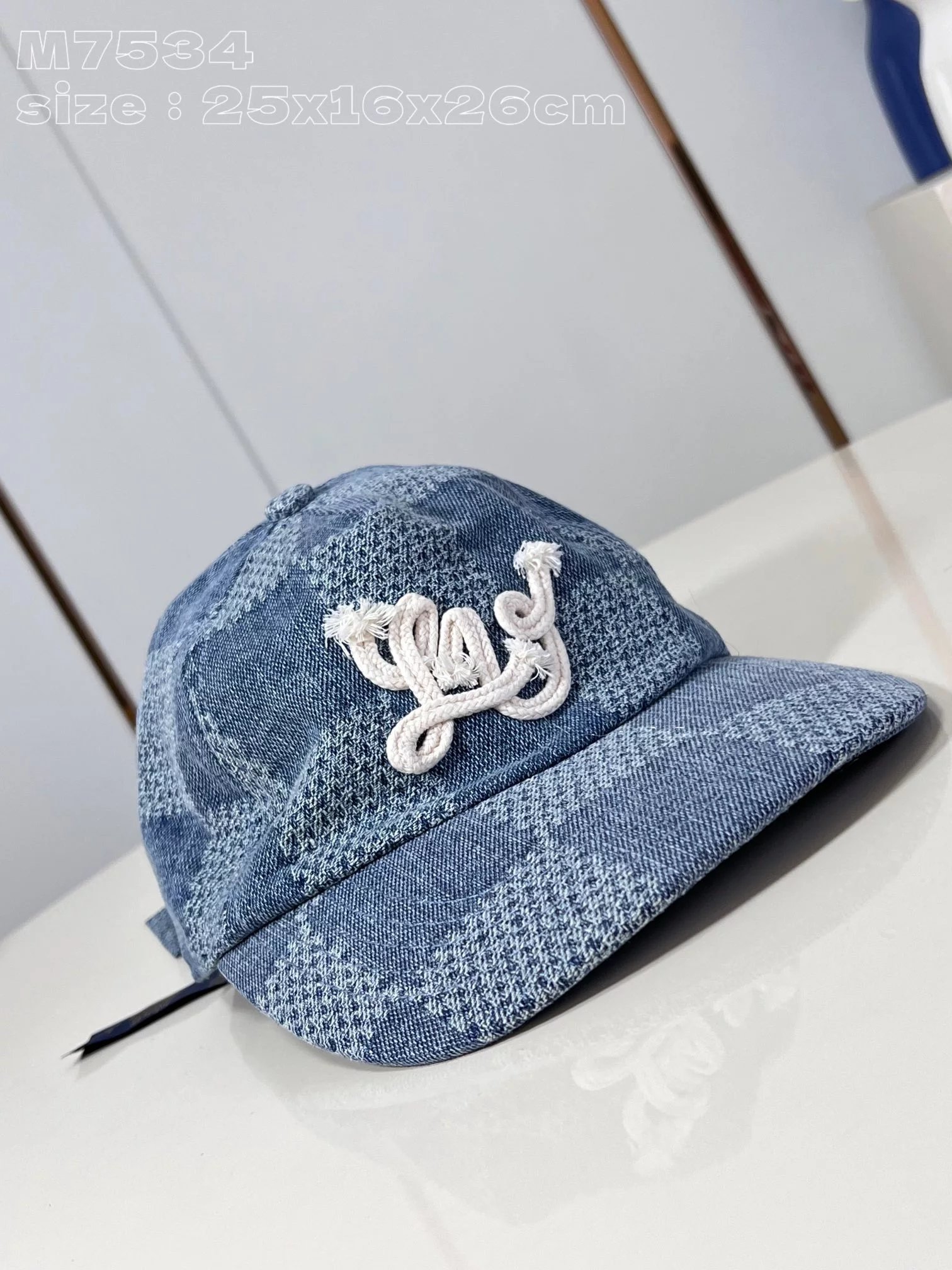 Top‑grade, original‑issue M7534 Damier Denim 3D baseball cap crafted from denim, featuring a fresh take on the iconic check pattern reimagined by Pharrell Williams for the Spring/Summer 2024 runway, with bold cord embroidery adorning the prominent peak above the brim...