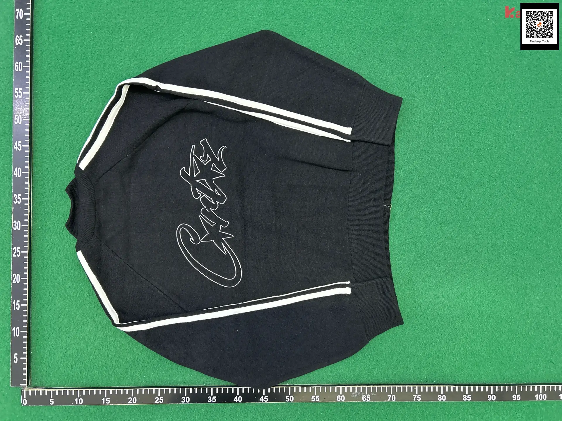 Black sweater with white trim and graphic