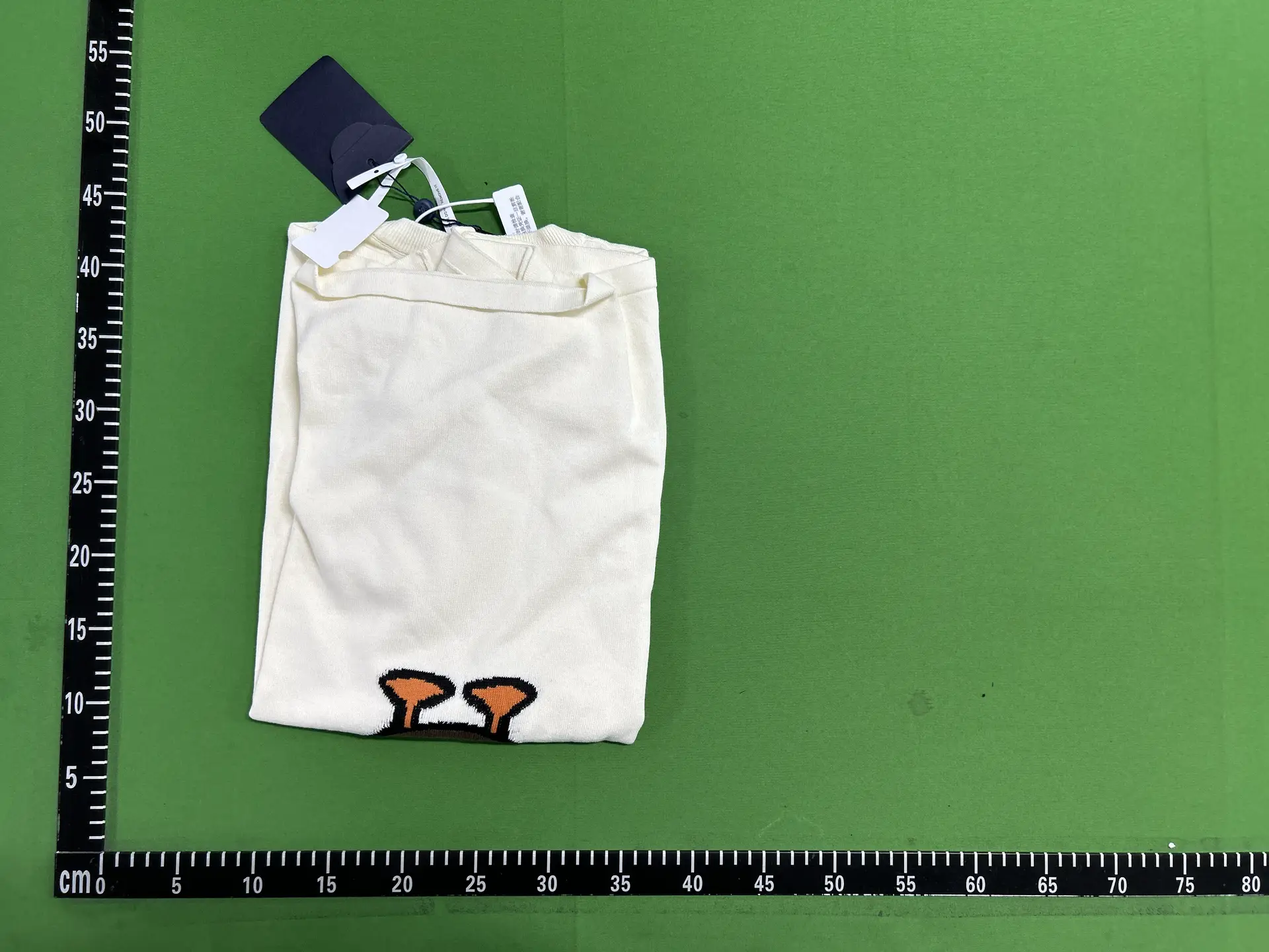Cream sweater with orange graphic